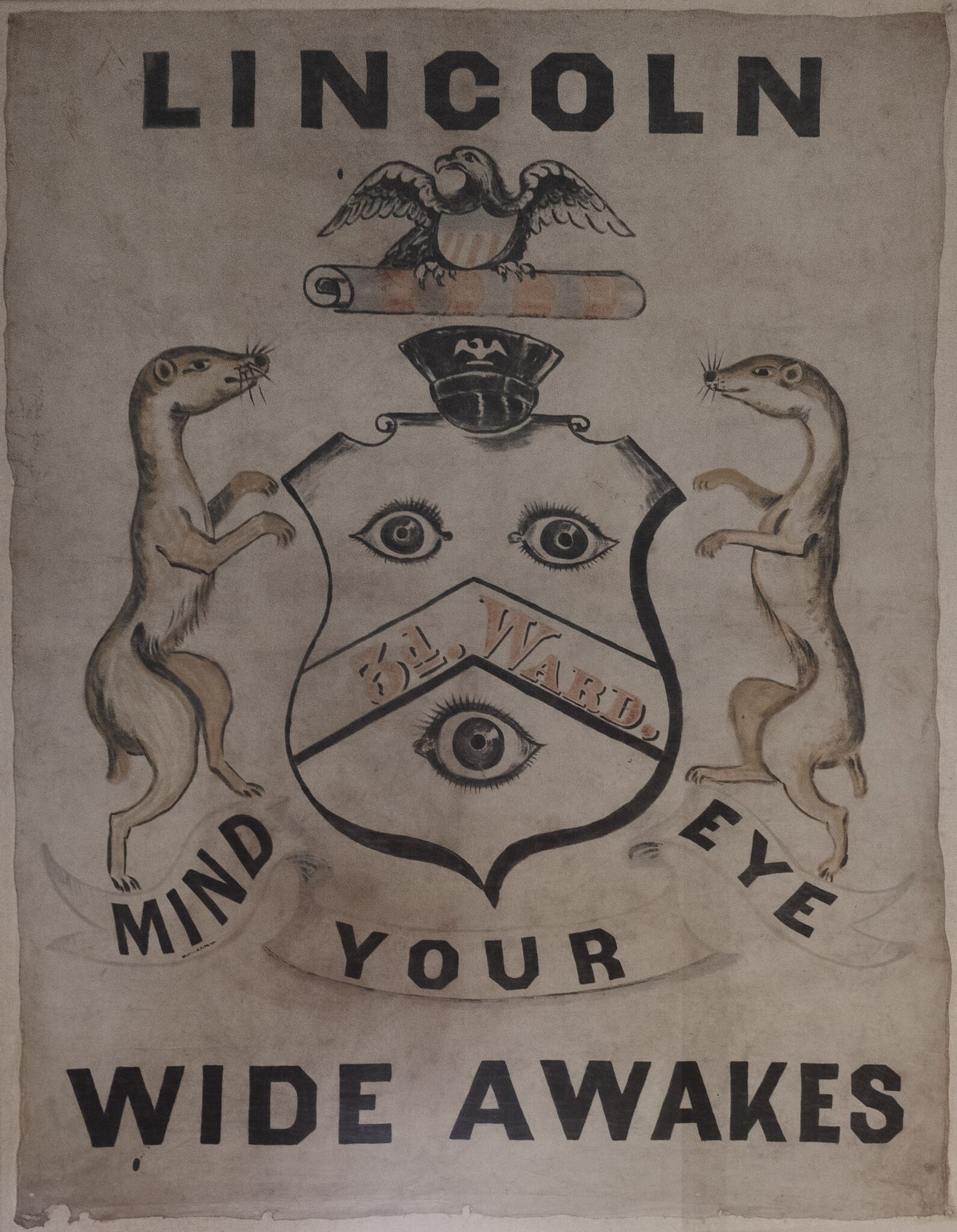 Wide Awakes banner, on display at the Old Capitol building, Springfield, Illinois. Shows a shield with 3 eyes on it with 2 dancing weasels beside it. Reads: Lincoln Wide Awakes. Mind Your eye.By Michael Christensen - Own work, CC BY-SA 4.0, https://commons.wikimedia.org/w/index.php?curid=53164849